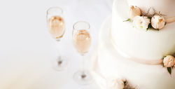 Wedding Cake And Champagne Flutes On Table